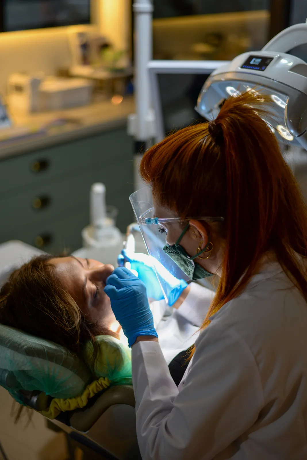 Curing light used during chairside treatment, shown while covering Dental Implant Cost in Toronto