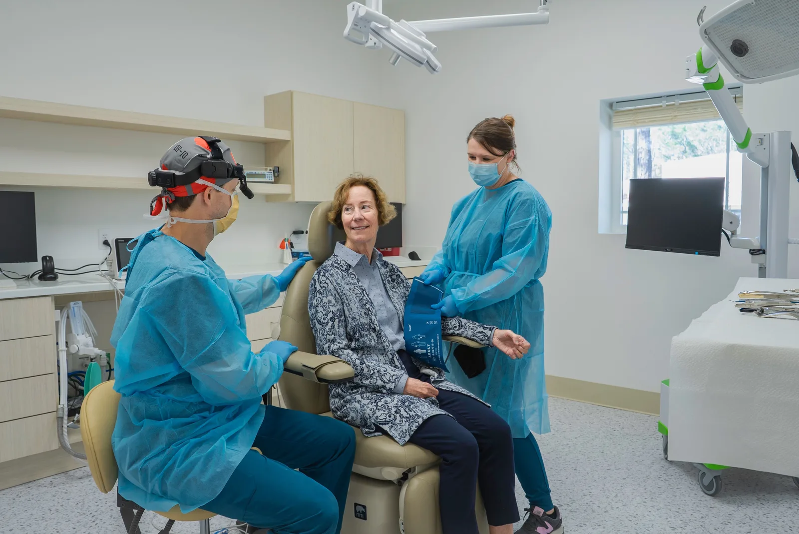 Dental team with a patient in the operatory, shown while covering Socket Preservation in Toronto
