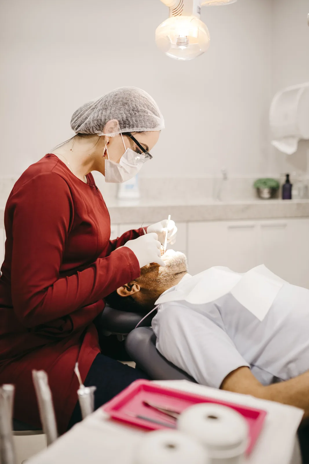 Dentist working under the operatory light, referred to in the Implant Procedures section for Toronto