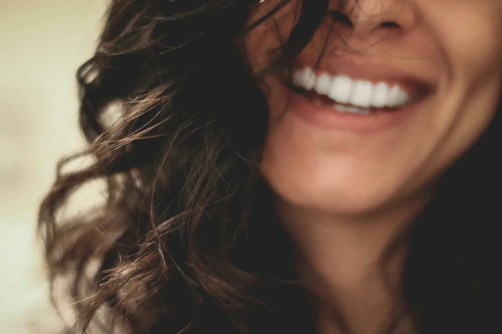 Patient smiling after dental implant treatment, shown while covering Same Day Implants in Toronto