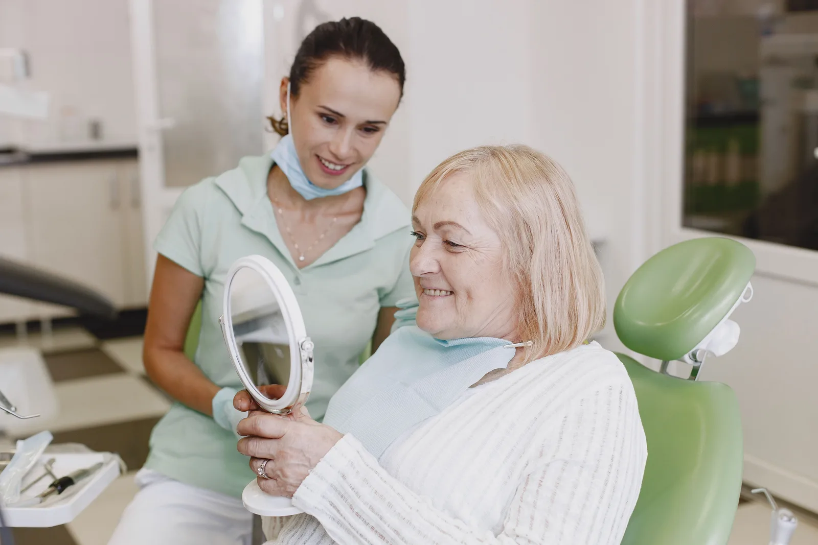 Reviewing the finished smile with the patient, alongside the Implant Lifespan explanation in Toronto