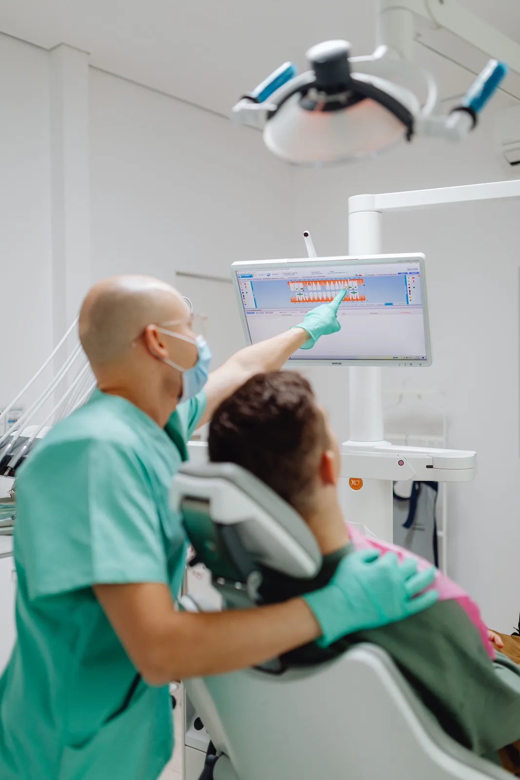 Reviewing the treatment plan on the chairside screen, alongside the Dentures Vs Implants explanation in Toronto
