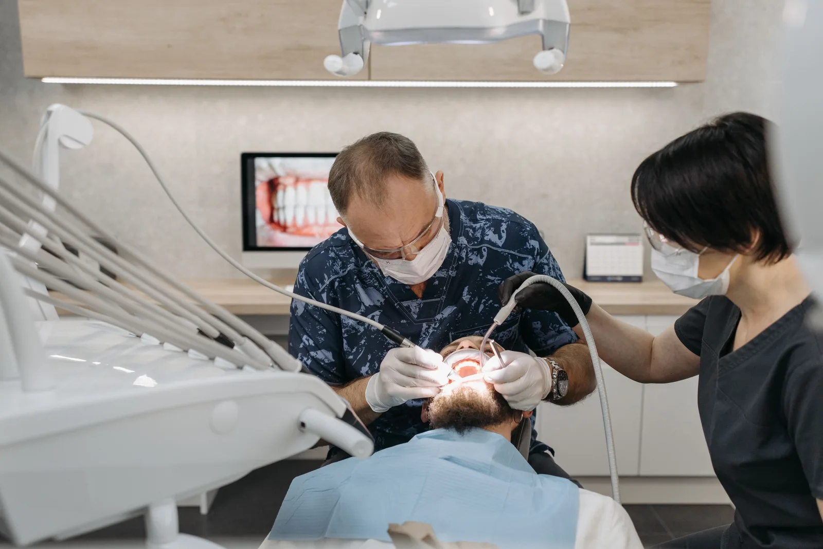 Dentist and assistant working together during treatment, referred to in the All-on-6 Implants section for Toronto